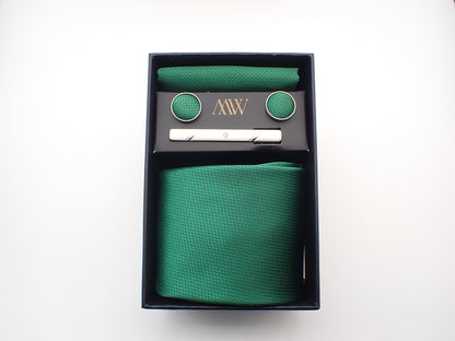 A black presentation box containing a rich emerald green micro-woven men's necktie, matching pocket square, round cufflinks, and a silver tie clip.