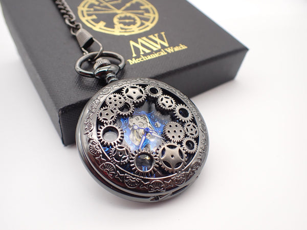 Gunmetal black mechanical pocket watch with cogwheel cover revealing vibrant blue internal gears, ideal for groomsmen gifts.