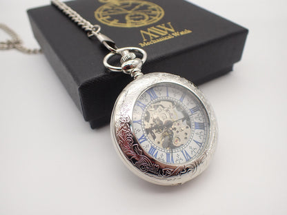 Silver hand-wind mechanical skeleton pocket watch featuring blue Roman numerals and intricate floral engraving, perfect for groomsmen gifts.