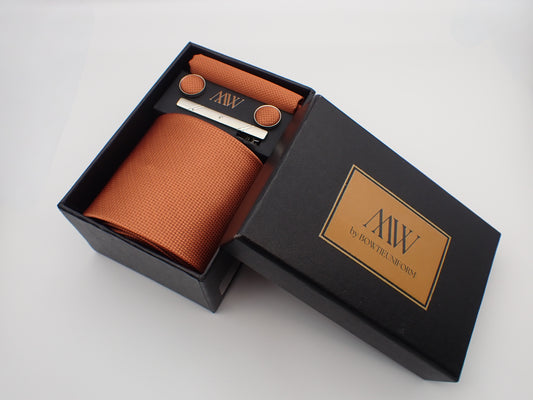 Trendy terracotta rust necktie with a sophisticated woven geometric texture, ideal for rustic wedding themes.