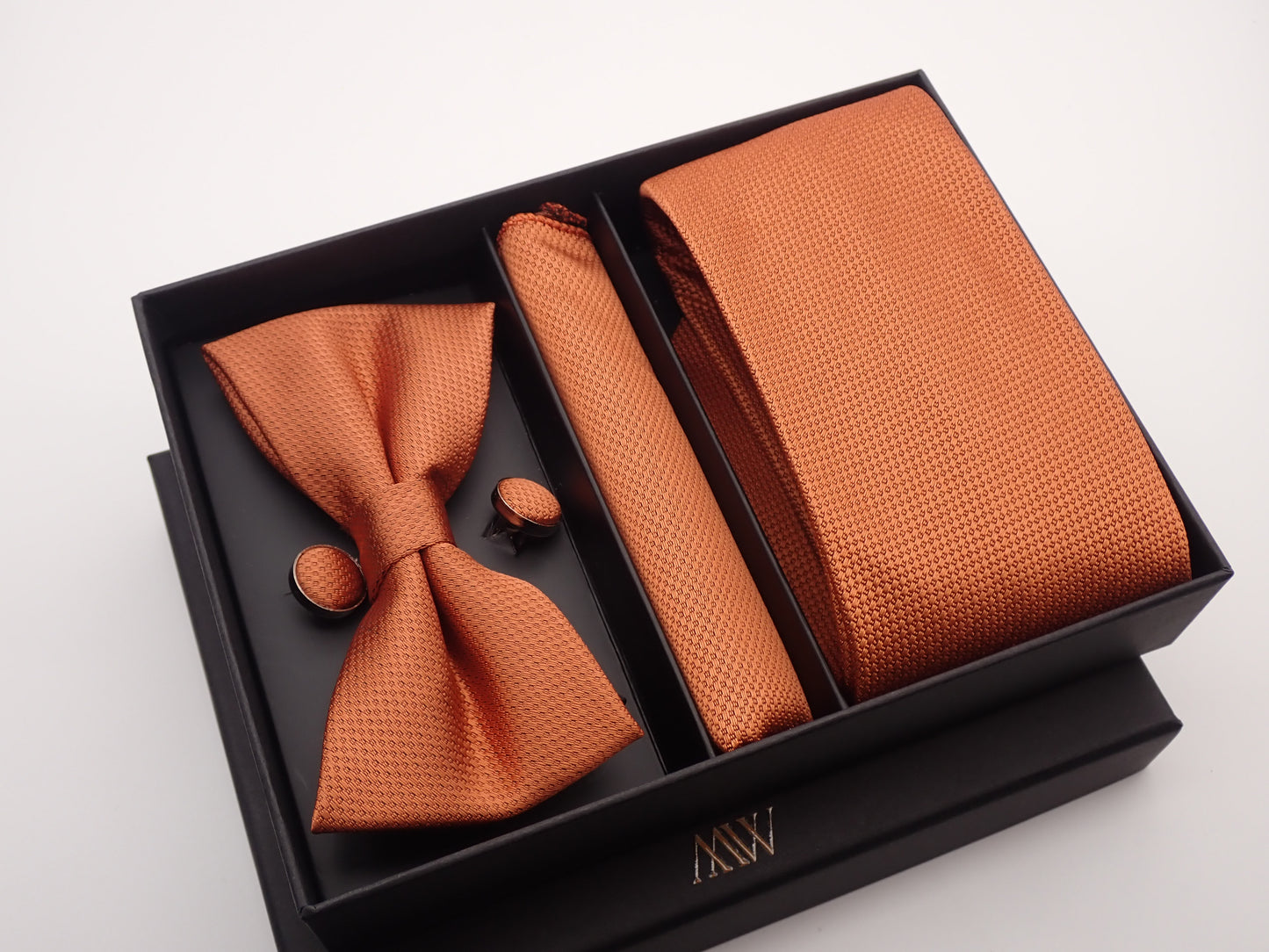 Trendy terracotta rust necktie with a sophisticated woven geometric texture, ideal for rustic wedding themes.