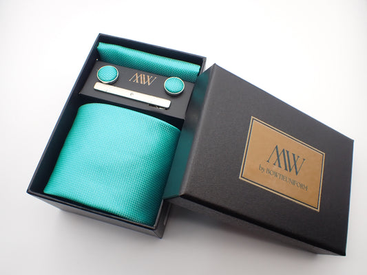 A black gift box containing a bright turquoise blue textured men's necktie, matching pocket square, round cufflinks, and a silver tie clip.